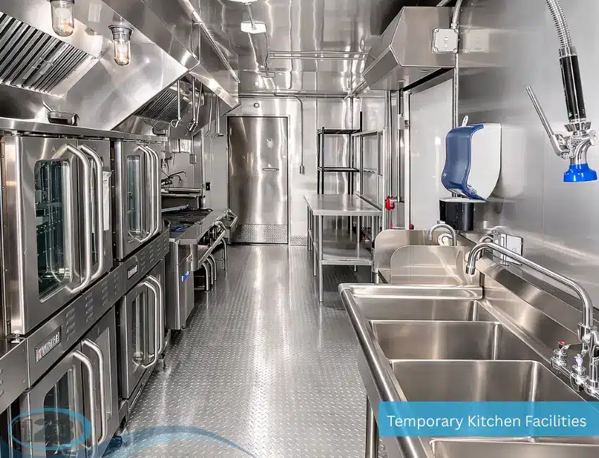 Portable commercial kitchen workspace featuring cooking stations and stainless steel fixtures