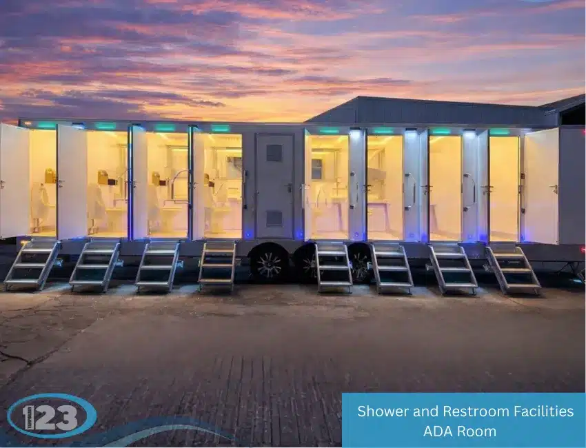 Large shower and restroom trailer at dusk with illuminated open private stalls